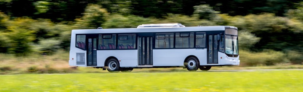 large white bus driving