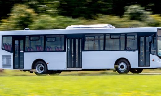 large white bus driving