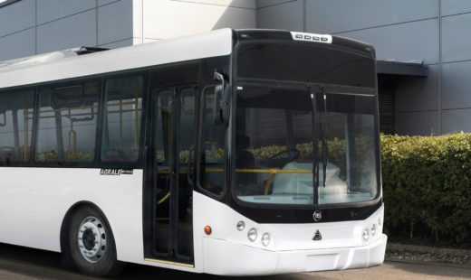 Large white electric bus infront of engineering centre