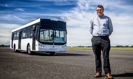 Ian Foley standing in front of electric bus conversion prototype